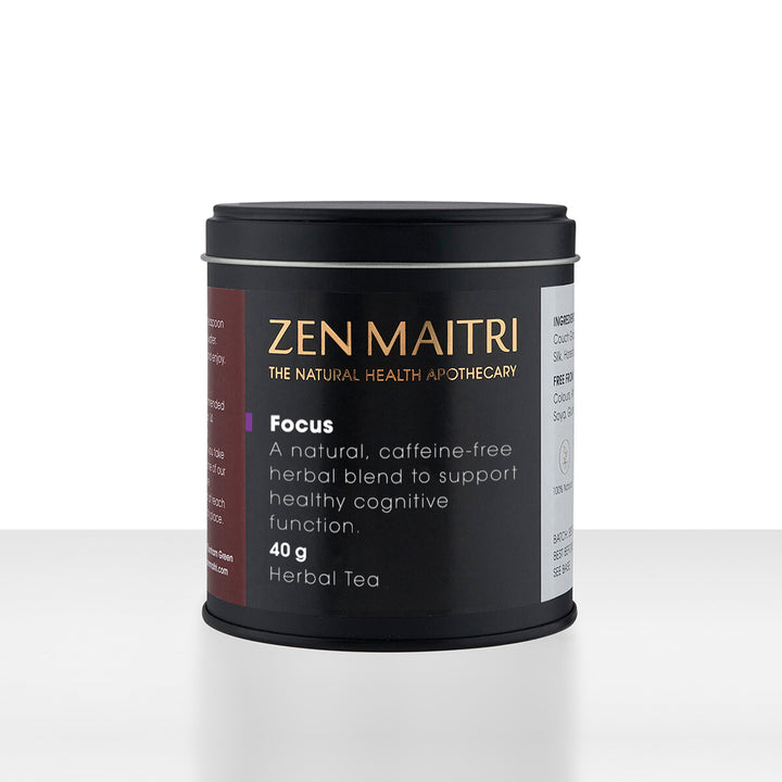 A black cylindrical tin of Zen Maitri Focus herbal tea by The Natural Health Apothecary, set against a clean white background with a soft reflection.