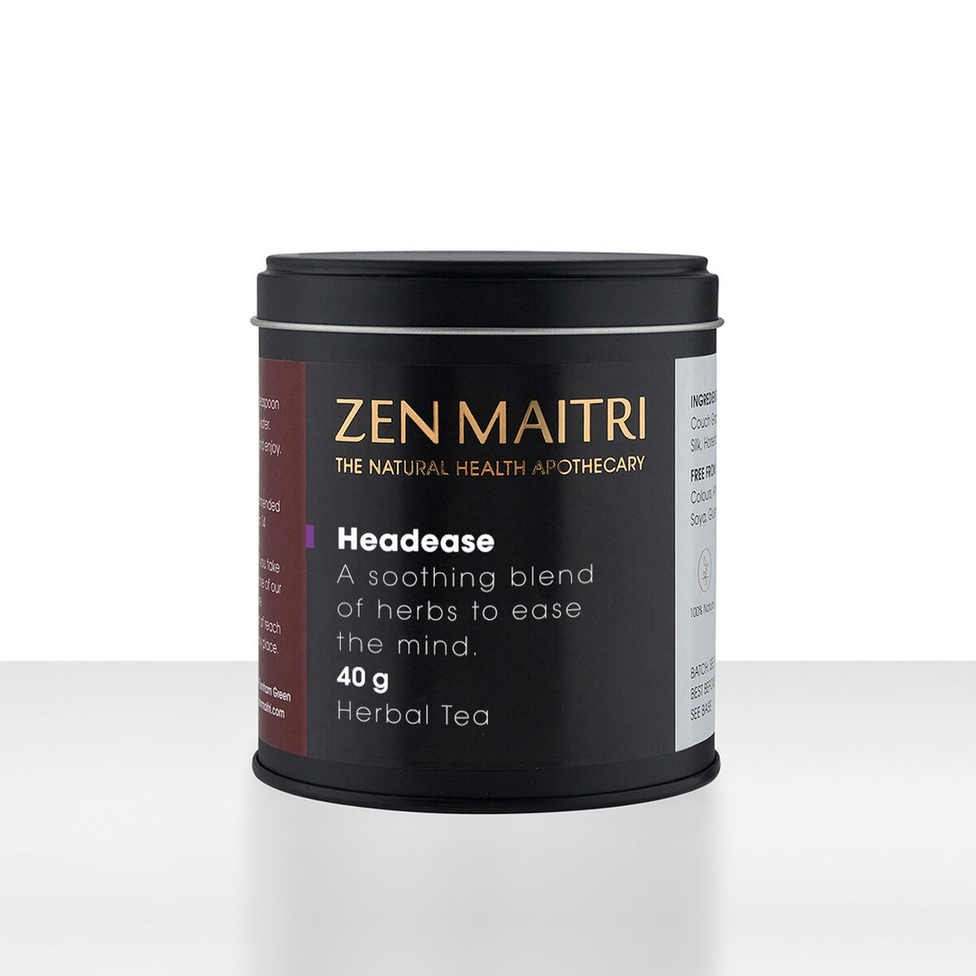 Zen Maitri Headease herbal tea in a matte black cylindrical tin with a matching lid, set against a clean white background with a subtle reflection.