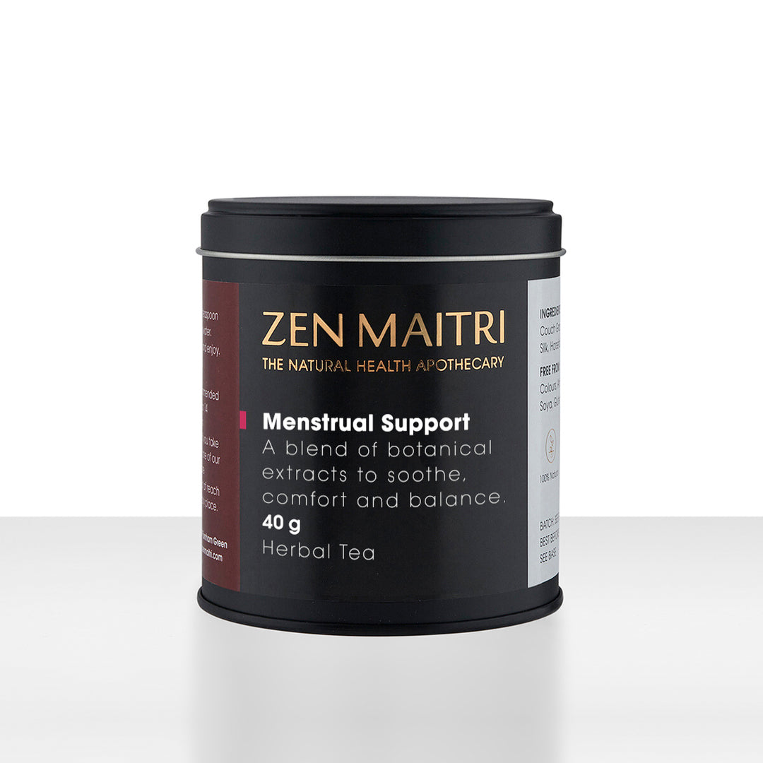 A black cylindrical tin of Zen Maitri Menstrual Support Herbal Tea on a clean white background. The label features gold lettering for the brand name and white text detailing the product benefits and weight.