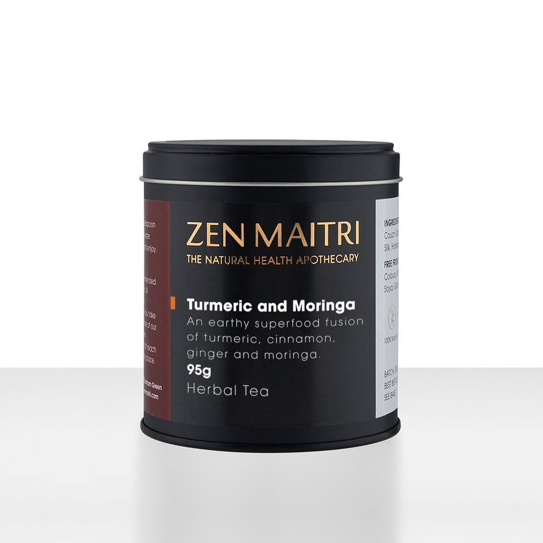 Zen Maitri Turmeric and Moringa herbal tea in a matte black cylindrical tin with a black lid, set against a clean white background with a subtle reflection.